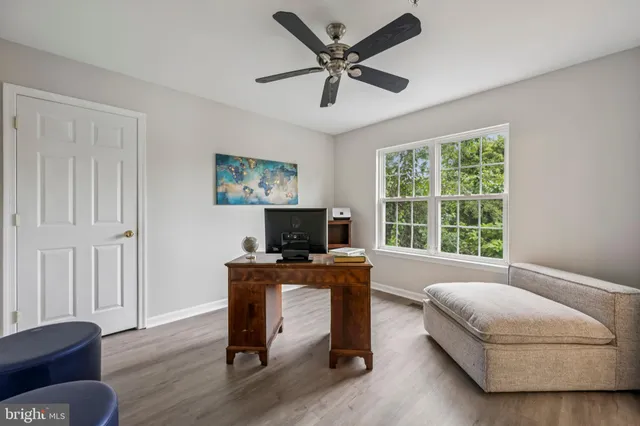 a livingroom with workspace and a window