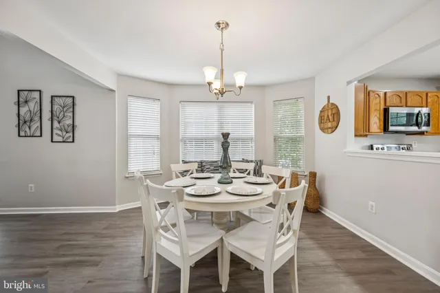 a view of a dining room with furniture wooden floor and chandelier