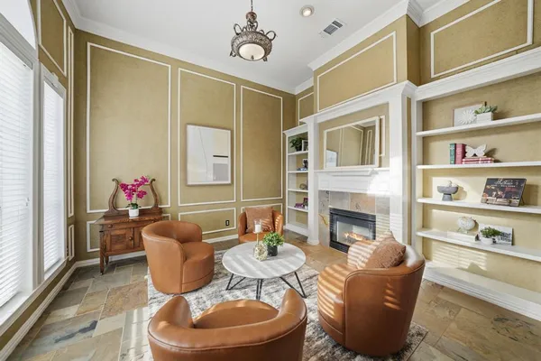 a dining room with furniture a fireplace and wooden floor