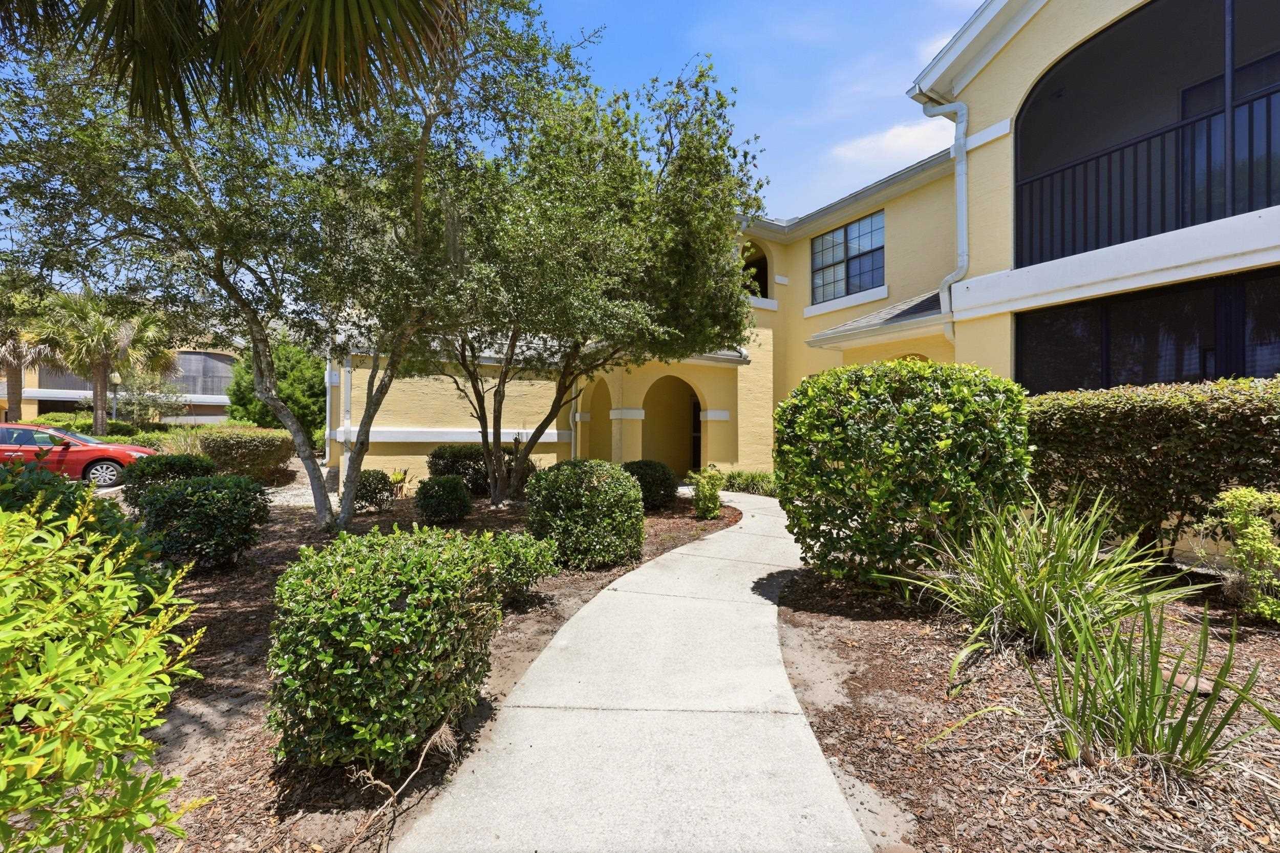 2500 Vista Cove Road St. Augustine, FL 32084 - Photo 47 of 53 a front view of a house with a yard and potted plants