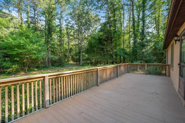 a view of a balcony with yard