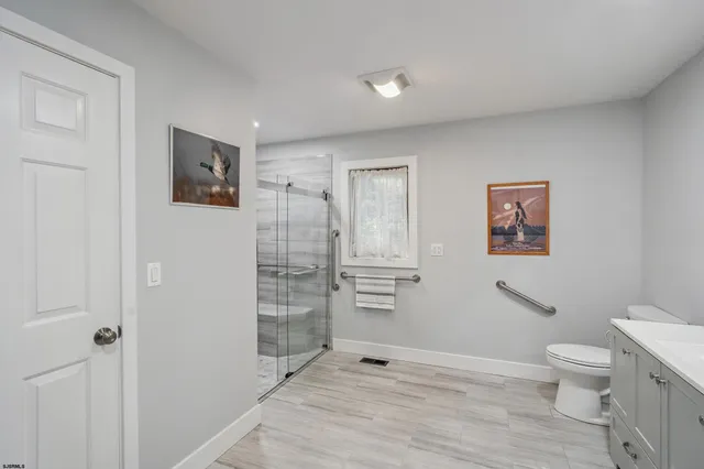 a bathroom with a shower toilet and sink
