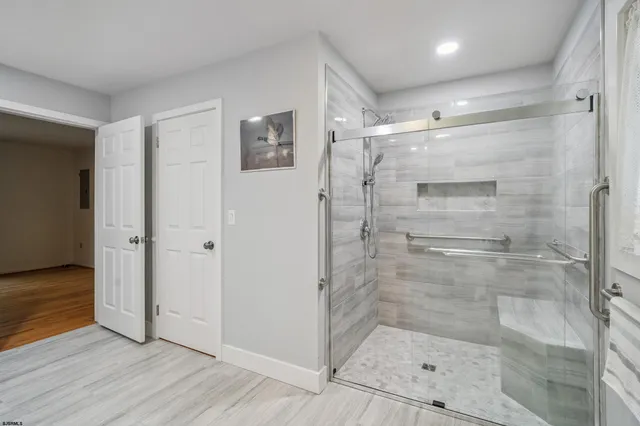 a bathroom with a glass shower door