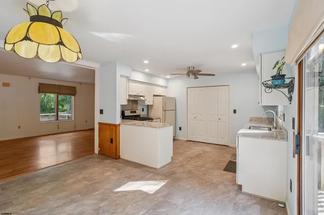 a view of kitchen and hall with wooden floor