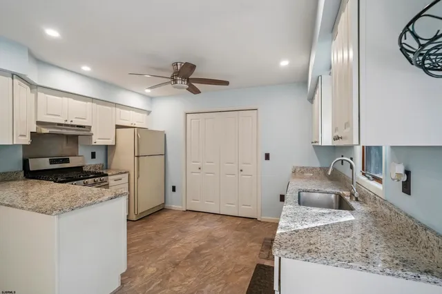 a kitchen with a sink stove and refrigerator