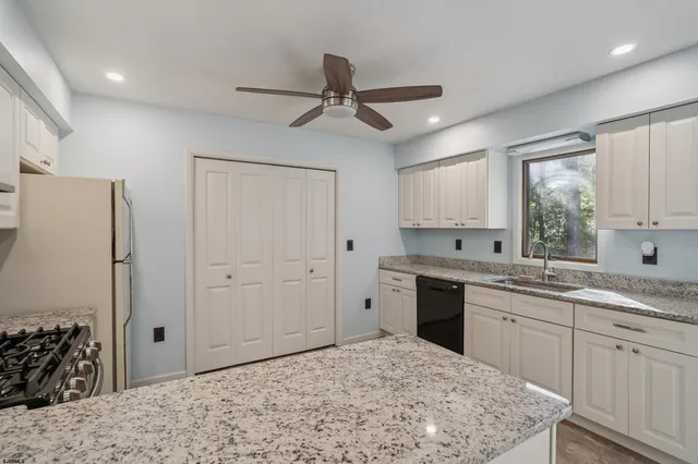 a kitchen with a stove a sink and a refrigerator