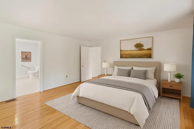 a bedroom with a bed and a painting on the wall