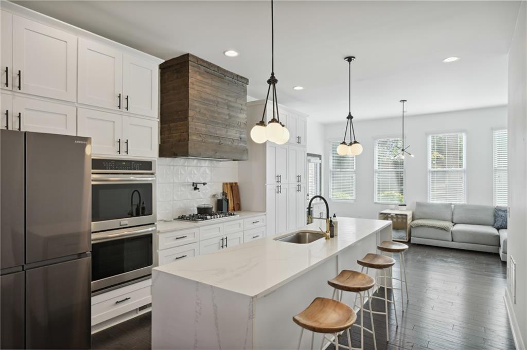 2059 Cogar Drive Decatur, GA 30032 - Photo 1 of 1 a kitchen with a sink a stove a refrigerator and white cabinets