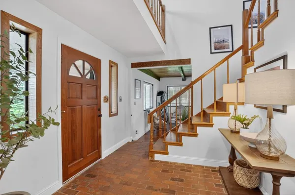 a view of entryway and hall with wooden floor