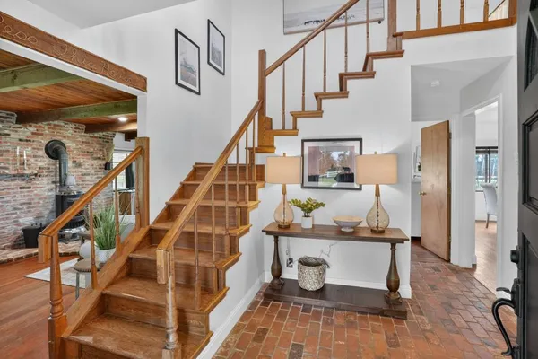 a view of entryway and hall with wooden floor