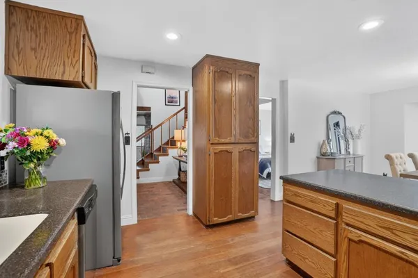 a kitchen with stainless steel appliances granite countertop a refrigerator and a sink