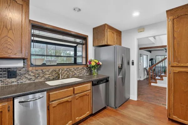 a kitchen with stainless steel appliances granite countertop a refrigerator and a sink