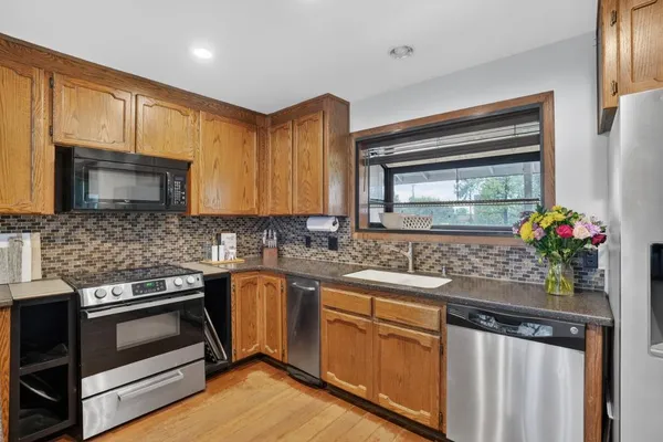 a kitchen with granite countertop stainless steel appliances and sink