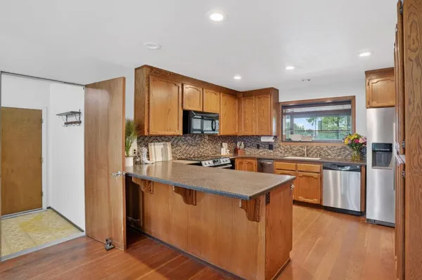 a kitchen with stainless steel appliances granite countertop a sink stove and refrigerator