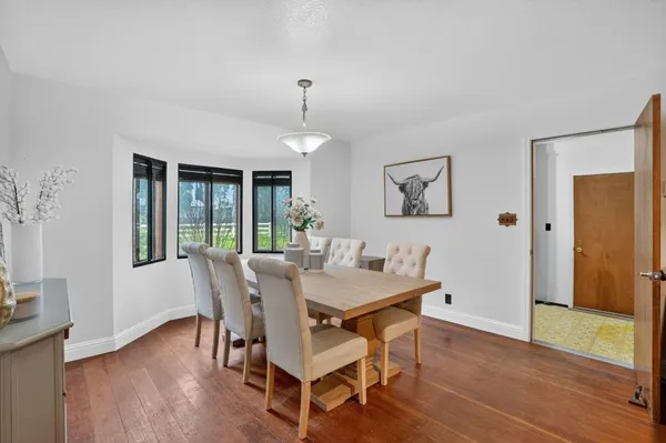 a view of a dining room with furniture window and wooden floor