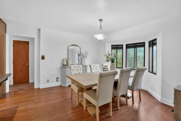 a view of a dining room with furniture window and wooden floor