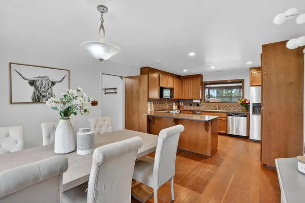 a dining room with furniture and kitchen view