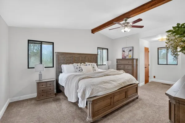 a bed room with a bed and a mirror