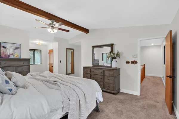 a bedroom with a bed and a chandelier