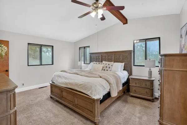 a bed room with a bed and a ceiling fan