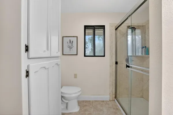 a bathroom with a toilet a sink and shower