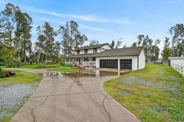 a front view of house with yard and green space
