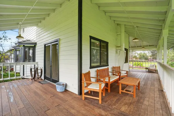 a balcony with furniture and a potted plant