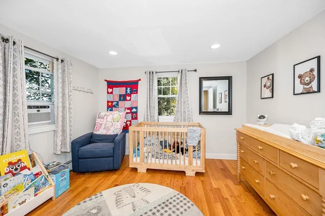 a living room with furniture and a baby crib