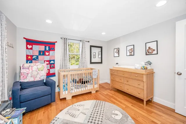 a bedroom with furniture and a baby crib