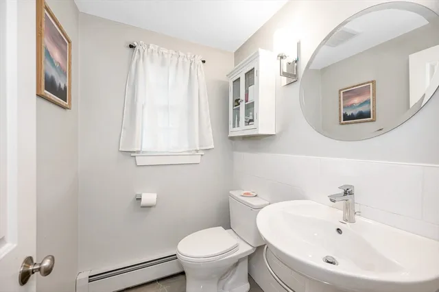 a white toilet sitting next to a bathroom sink