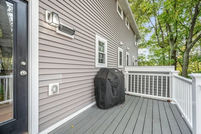 a view of a wooden balcony next to a house