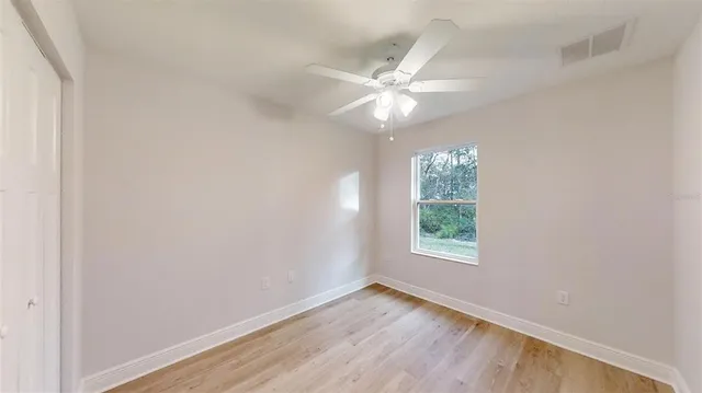 wooden floor in an empty room with a window
