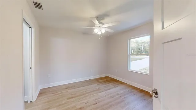 wooden floor in an empty room with a window