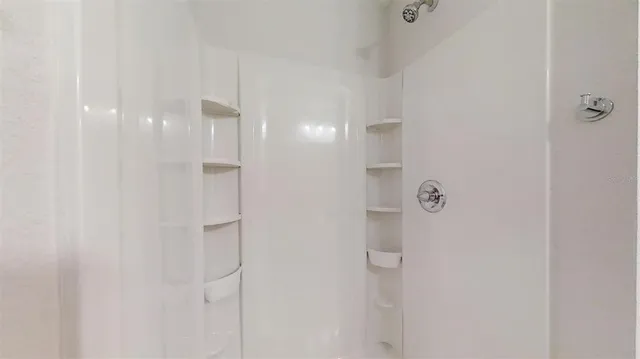 a bathroom with a granite countertop toilet sink and mirror