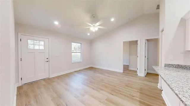 a large kitchen with stainless steel appliances granite countertop a stove a sink and a refrigerator