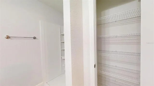 a large kitchen with kitchen island a large counter top and a refrigerator
