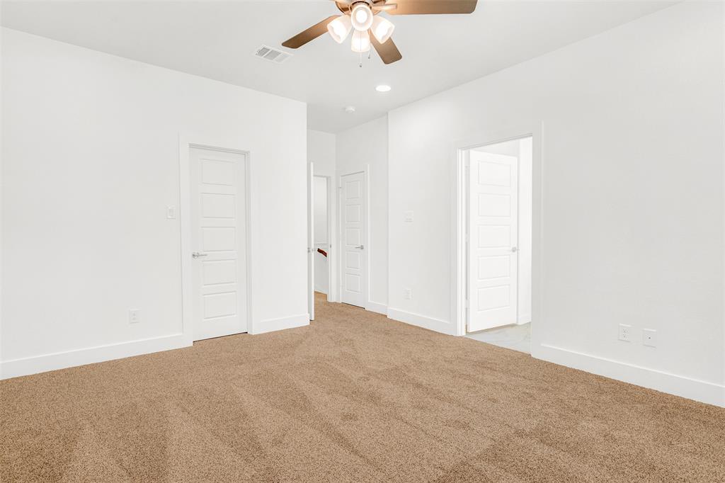 3676 Rickshaw Drive, Unit A Dallas, TX 75229 - Photo 17 of 21 Large master bedroom and door on the right leads to spa-like master bathroom. Door to the left leads into spacious his and hers closet