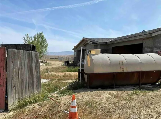 a view of walk in closet with window and small yard
