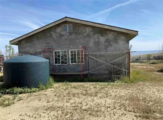 a view of a balcony with wooden floor and chair