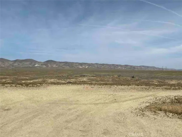 a view of a dinning table and chairs in the patio in front of a house