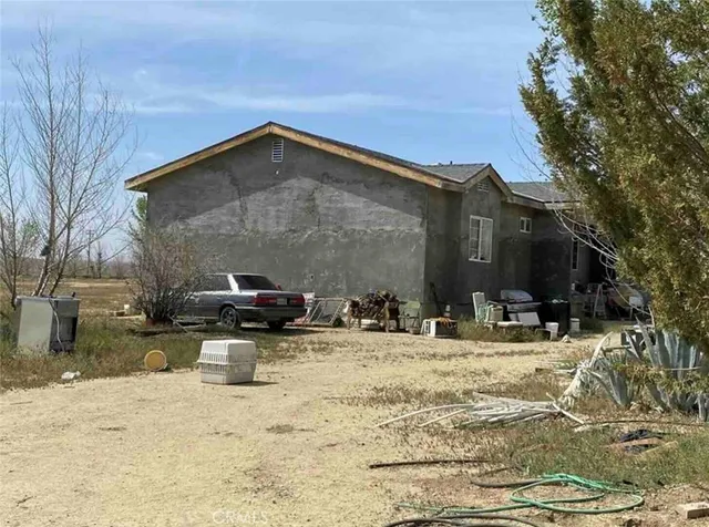 a view of dirt field with trees
