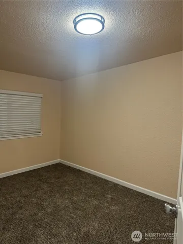 an empty room with a empty space and a window