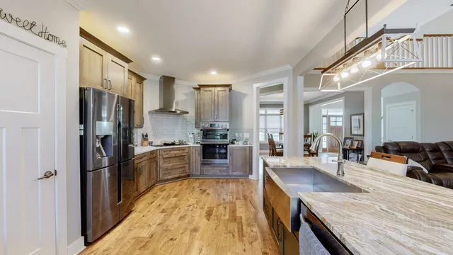a kitchen with stainless steel appliances kitchen island granite countertop a refrigerator and microwave