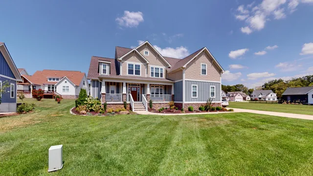 a front view of a house with a garden and sitting area