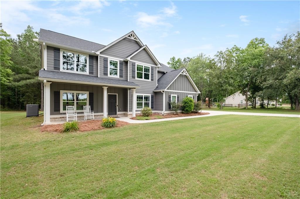 719 Fairview Road Brooks, GA 30205 - Photo 6 of 35 a front view of a house with swimming pool having outdoor seating
