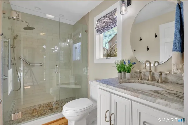 a bedroom with a bed and a view of living room