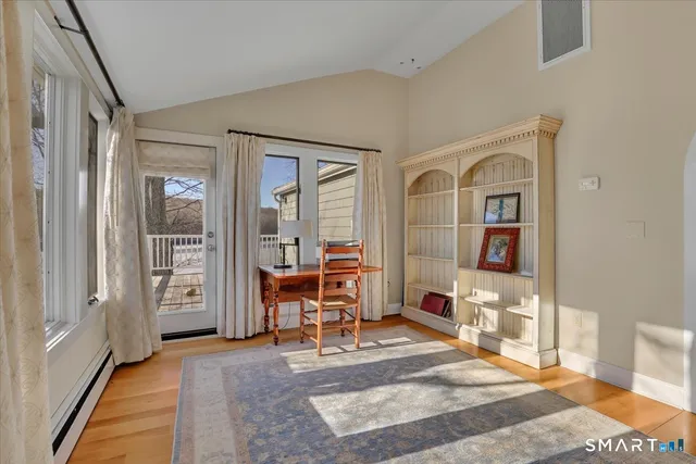 a view of a livingroom with wooden floor and a staircase
