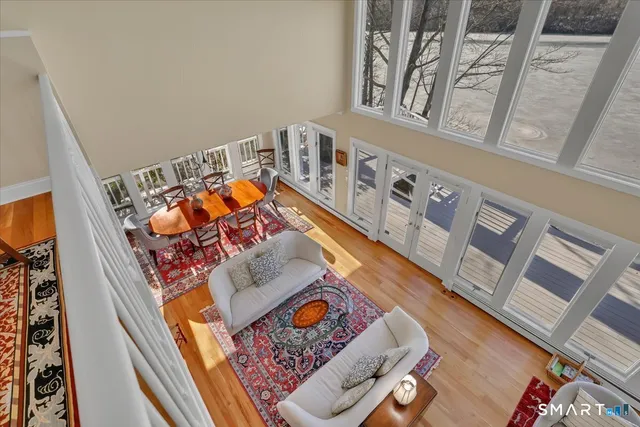 a spacious bedroom with a bed and wooden floor