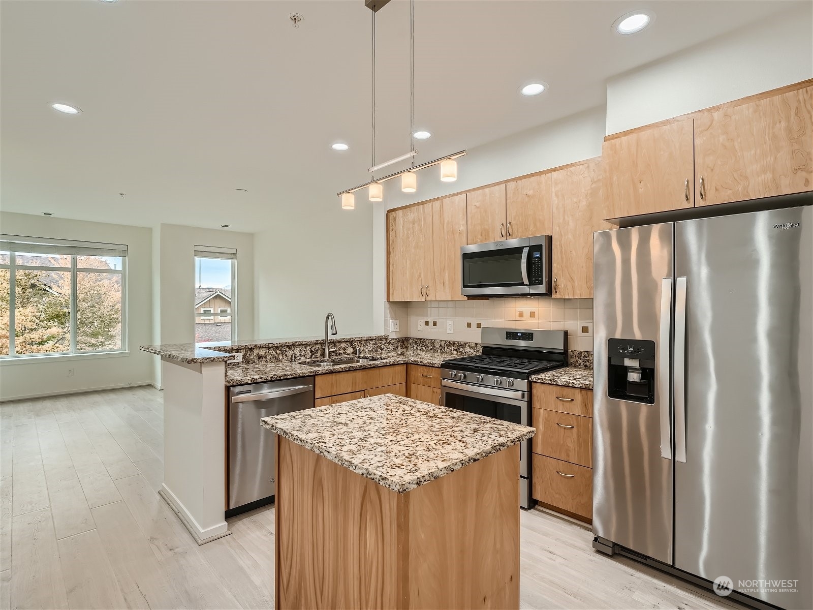 101 Sky Ridge Road Northwest, Unit 502 Issaquah, WA 98027 - Photo 11 of 31 a kitchen with a stove a refrigerator and a microwave