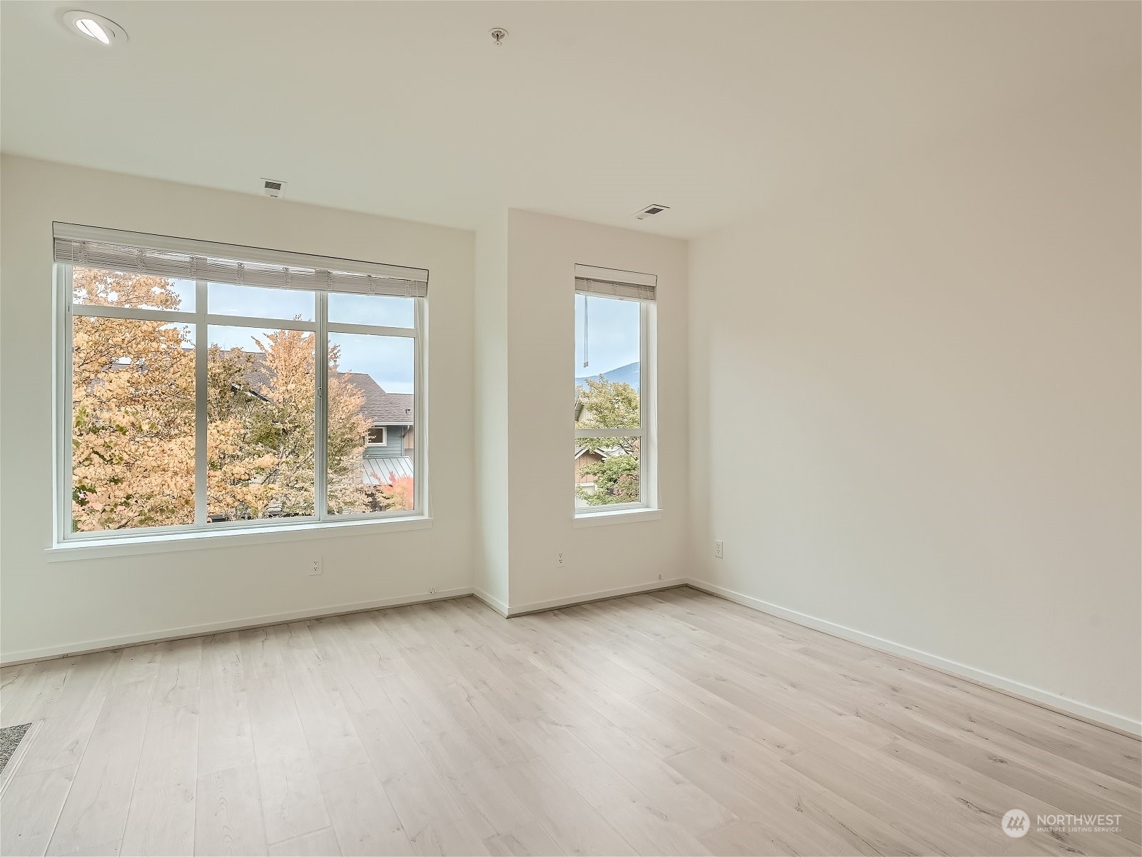101 Sky Ridge Road Northwest, Unit 502 Issaquah, WA 98027 - Photo 15 of 31 an empty room with wooden floor and windows